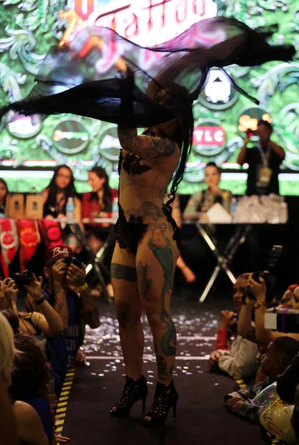 A tattooed model performs during the Tattoo Week SP 2016 in Sao Paulo, Brazil, July 23, 2016. (Photo by Paulo Whitaker/Reuters)
