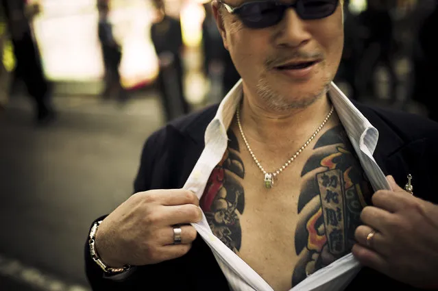Yakuza street fighter aggressively showing off his tattoo in Kabukicho, Shinjuku, Tokyo – 2010. (Photo and caption by Anton Kusters)