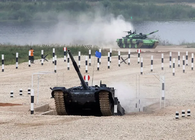Tanks drive on the course of the Tank Biathlon competition during the International Army Games 2016 in Alabino, outside Moscow, Russia, July 30, 2016. (Photo by Maxim Zmeyev/Reuters)
