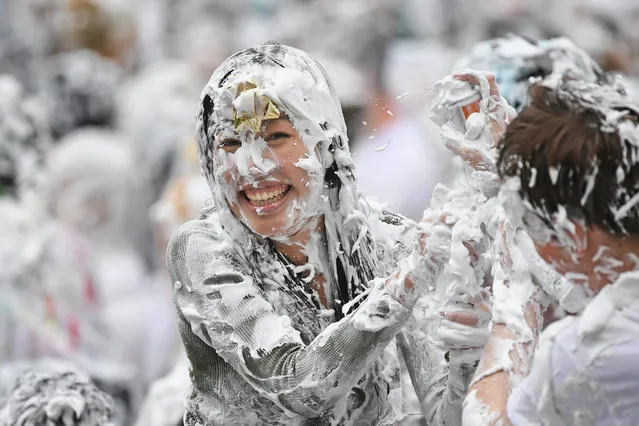 Students from St Andrews University indulge in a tradition of covering themselves with foam to honour the “academic family” on the lower college lawn on October 23, 2017, in St Andrews, Scotland. (Photo by Jeff J. Mitchell/Getty Images)