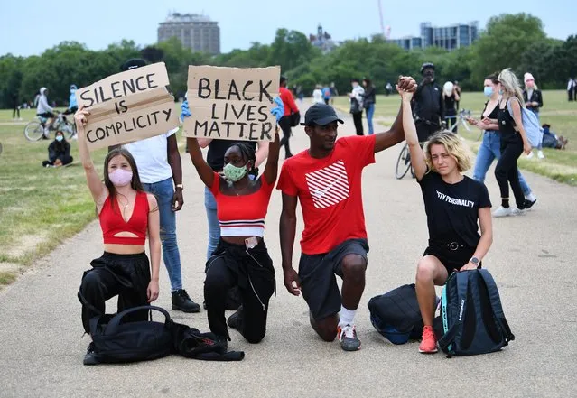 People kneel as they hold banners in Hyde Park during a “Black Lives Matter” protest following the death of George Floyd who died in police custody in Minneapolis, London, Britain, June 3, 2020. (Photo by Dylan Martinez/Reuters)