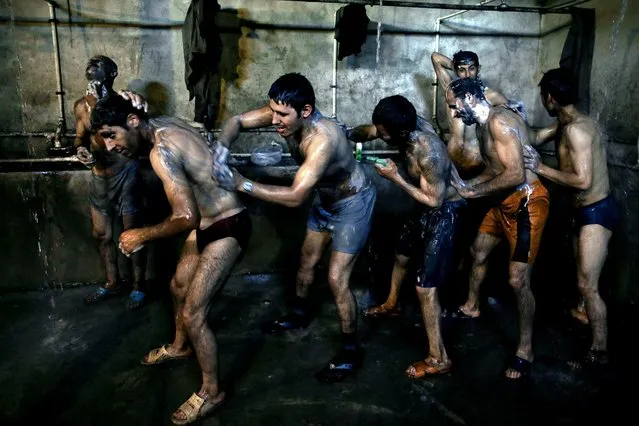 In this Tuesday, May 6, 2014 photo, Iranian coal miners shower after a long day of work at a mine on a mountain in Mazandaran province, near the city of Zirab, 212 kilometers (132 miles) northeast of the capital Tehran, Iran. (Photo by Ebrahim Noroozi/AP Photo)