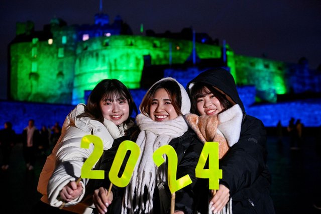 Japanese students visiting Edinburgh enjoy themselves during the Hogmanay street party celebrations, in Edinburgh, Scotland, Britain on December 31, 2023. (Photo by Lesley Martin/Reuters)