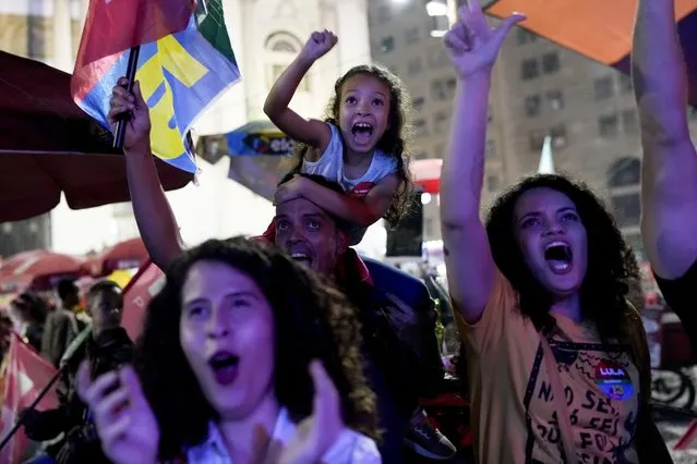 Followers of former Brazilian President Luiz Inacio “Lula” da Silva, who is running for president again, react as they listen to the partial results after general election polls closed in Rio de Janeiro, Brazil, Sunday, October 2, 2022. (Photo by Silvia Izquierdo/AP Photo)