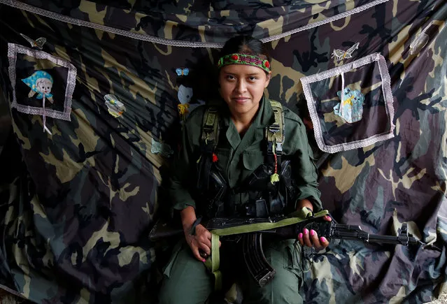 Leidi, a member of the 51st Front of the Revolutionary Armed Forces of Colombia (FARC), poses for a picture at a camp in Cordillera Oriental, Colombia, August 16, 2016. (Photo by John Vizcaino/Reuters)
