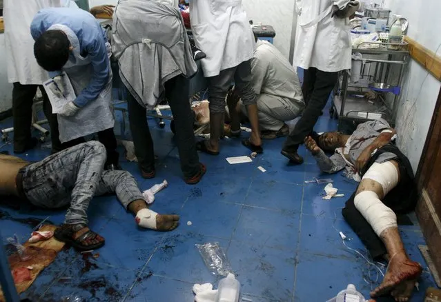 People lie on the floor of a hospital after they were injured by a shell that landed in a residential area during fighting between Houthi militants and pro-government militants in Yemen's southwestern city of Taiz September 24, 2015. (Photo by Reuters/Stringer)