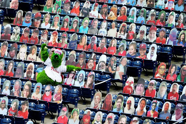 The Phillie Phanatic shows off the foul ball he caught amongst the cardboard cutout fans during an MLB baseball game between the Philadelphia Phillies and New York Mets at Citizens Bank Park on August 16, 2020 in Philadelphia, Pennsylvania. The Phillies defeated the Mets 6-2. (Photo by Rich Schultz/Getty Images)