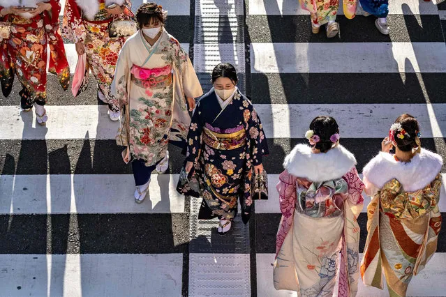 Young women wear kimonos to mark “Coming of Age Day” to honour people who turn 20 this year to signify adulthood, in Yokohama, Kanagawa prefecture on January 9, 2023. (Photo by Philip Fong/AFP Photo)
