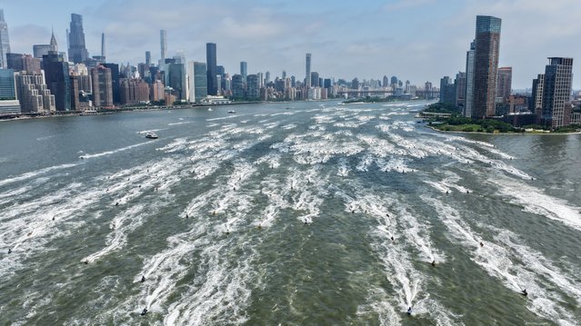 Hundreds of jet skiers take part in the annual NYC Jet ski Invasion riding through the East River and Hudson River past Manhattan's skyline in New York, United States on Saturday, June 28, 2025. (Photo by Lokman Vural Elibol/Anadolu via Getty Images)