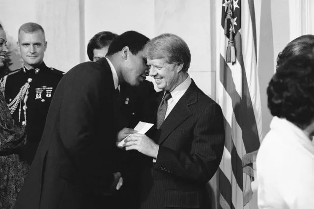 Heavyweight champion Muhammad Ali hands President Jimmy Carter tickets to his next fight during a reception at the White House in Washington on Wednesday, September 7, 1977 after the signing of the Panama Canal treaty. Ali will face Ernie Shavers later this month at Madison Square Garden. (Photo by AP Photo)