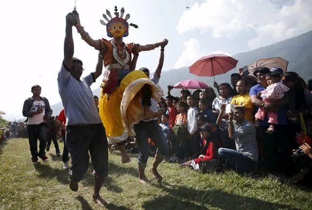 A medium dressed as a deity jumps during a trance at Khokana village in Lalitpur, Nepal October 19, 2015. (Photo by Navesh Chitrakar/Reuters)