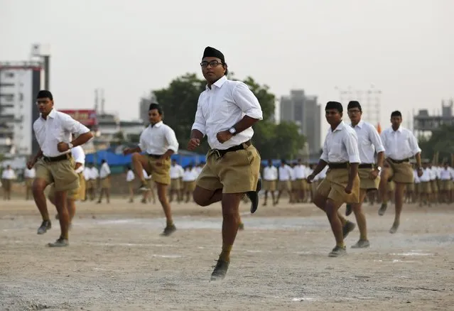 Volunteers of the Hindu nationalist organisation Rashtriya Swayamsevak Sangh (RSS) exercise as they take part in the "Path-Sanchalan", or Volunteer March during celebrations to mark the Vijaya Dashmi or Dussehra in Ahmedabad, India, October 18, 2015. (Photo by Amit Dave/Reuters)