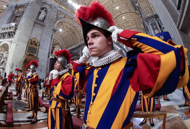 Guardsmen adjust their casques during a mass for the new Swiss Guards recruits in St. Peter’s Basilica, Vatican City State on October 4, 2020. (Photo by Evandro Inetti/ZUMA Wire/Rex Features/Shutterstock)