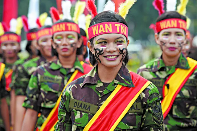Female members of the Indonesian military attend a roll call to mark Kartini Day in Jakarta on April 22, 2013. The event is held to enhance integrity and solidarity for Indonesian women commemorating the birth of Raden Ajeng Kartini, an Indonesian heroine born in 1879, a pioneer in the emancipation of Indonesian women. (Photo by Adek Berryadek Berry/AFP Photo)