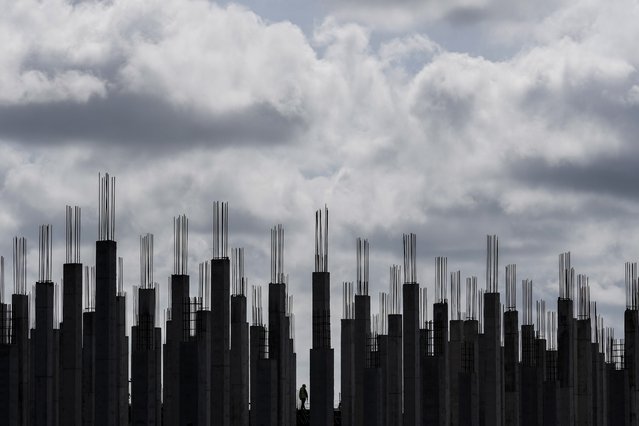 A worker walks through a building under construction in Georgetown, Guyana, Tuesday, September 2, 2025. (Photo by Matias Delacroix/AP Photo)