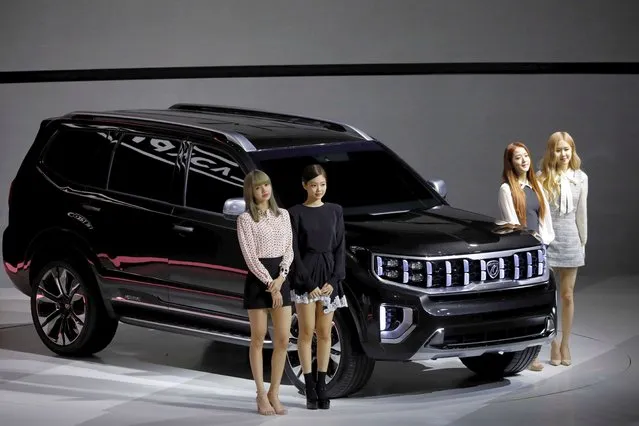 Members of K-pop idol group Black Pink pose for photographs with Kia Motors' Mohave during the 2019 Seoul Motor Show in Goyang, South Korea on March 28, 2019. (Photo by Kim Hong-Ji/Reuters)