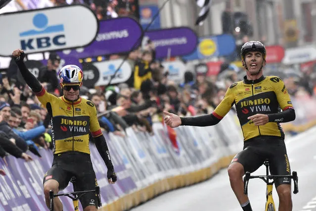 France's Christophe Laporte, right, and Belgium's Wout Van Aert of the Jumbo Visma team cross the finish line to take first and second place in the Gent-Wevelgem cycling race in Wevelgem, Belgium, Sunday, March 26, 2023. (Photo by Geert Vanden Wijngaert/AP Photo)