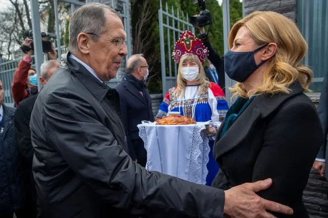 Russian Foreign Minister Sergey Lavrov, left, greets former Croatian President Kolinda Grabar-Kitarovic, in front of the Russian embassy in Zagreb, Croatia, Wednesday, Dec. 16, 2020. Lavrov is on a one-day visit to Croatia. (Photo by Darko Bandic/AP Photo)