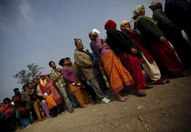 People queue to buy firewood from a government depot after the government started selling it to the public from Sunday, as a respite for the ongoing fuel and cooking gas shortages in Kathmandu, Nepal November 16, 2015. (Photo by Navesh Chitrakar/Reuters)