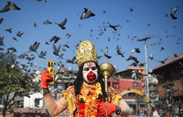 A Hindu Sadhu (holy man) dressed as Hanuman the monkey god, poses ahead for a picture ahead of the forthcoming Hindu festival of “Maha Shivaratri” at the Pashupatinath temple in Kathmandu on February 11, 2018. (Photo by Prakash Mathema/AFP Photo)