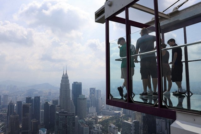 People look at Kuala Lumpur's skyline from an observation deck, in Kuala Lumpur, Malaysia on July 31, 2025. (Photo by Hasnoor Hussain/Reuters)