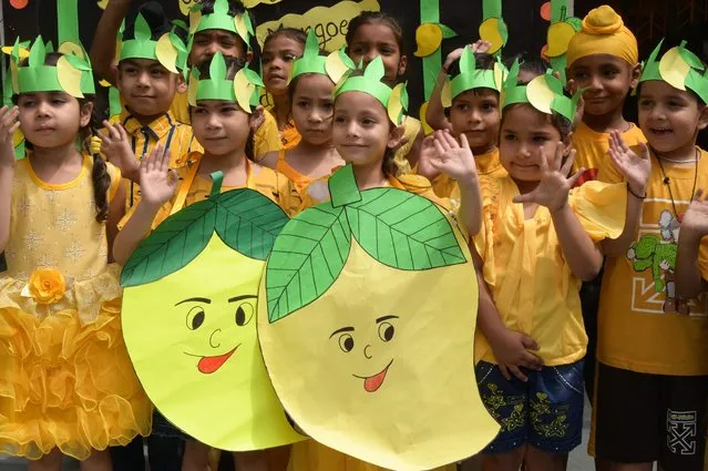 Children take part in the celebrations for the upcoming Mango Day at a school in Amritsar on May 25, 2023. (Photo by Narinder Nanu/AFP Photo)