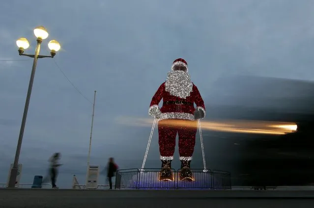 A giant illuminated Santa Claus is seen on the Promenade Des Anglais as part of holiday season decorations in Nice, France, December 14, 2015. (Photo by Eric Gaillard/Reuters)