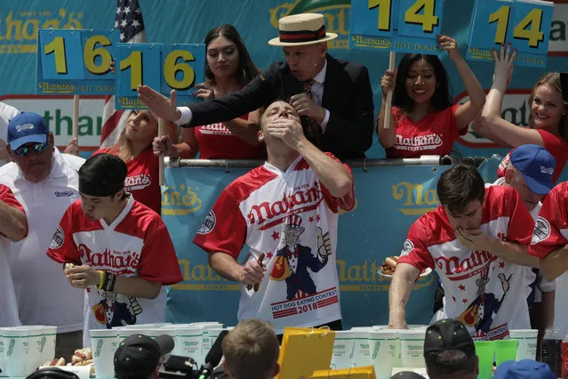 Joey Chestnut wins the annual Nathan's Hot Dog Eating Contest, setting a new world record by eating 74 hot dogs  in Brooklyn, New York City, U.S., July 4, 2018. (Photo by Stephen Yang/Reuters)