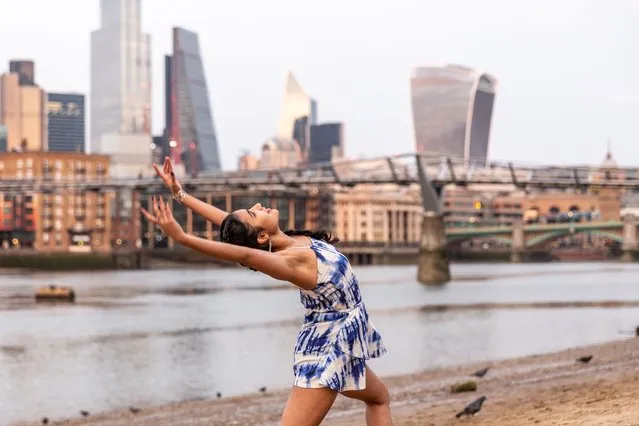 Young woman practices dance routine on a sandy beach in Southbank by the Thames river while the setting sun covers The City of London, the financial hub of the UK during an ongoing third Coronavirus lockdown on March 8, 2021. The Prime Minister Boris Johnson have set a road map on easing the restrictions. (Photo by Dominika Zarzycka/Sipa USA)