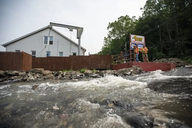 Water flows along a roadway impacted by recent storms and flooding, Monday, July 17, 2023, in Belvidere, New Jersey. (Photo by Eduardo Munoz Alvarez/AP Photo)