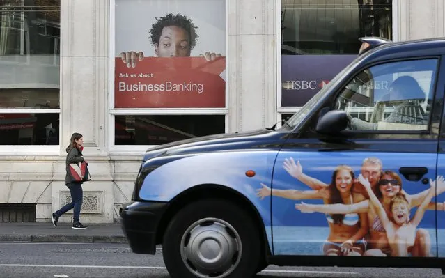 A woman walks past a branch of HSBC bank in London, February 9, 2015. British bank HSBC Holdings Plc admitted on February 8, 2015 failings by its Swiss subsidiary, in response to media reports it helped wealthy customers dodge taxes and conceal millions of dollars of assets. (Photo by Suzanne Plunkett/Reuters)