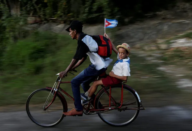 A man rides his bicycle with his son in Santiago de Cuba, Cuba, December 3, 2016. (Photo by Enrique de la Osa/Reuters)