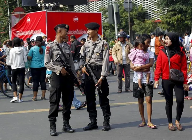 Indonesian police guard during a “car free” period at the site of this week's militant attack in central Jakarta, Indonesia, January 17, 2016. Indonesian police on Saturday named the five men they suspect launched this week's gun and bomb attack in Jakarta, which was claimed by Islamic State, and said they had arrested 12 people linked to the plot who planned to strike other cities. (Photo by Garry Lotulung/Reuters)