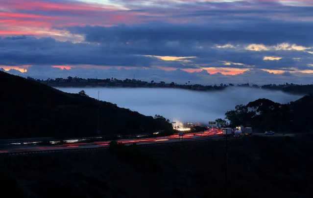 Morning fog rolls across Interstate Highway 5 as commuters in rush hour traffic start the day near Solana Beach, California, U.S. October 31, 2016. (Photo by Mike Blake/Reuters)