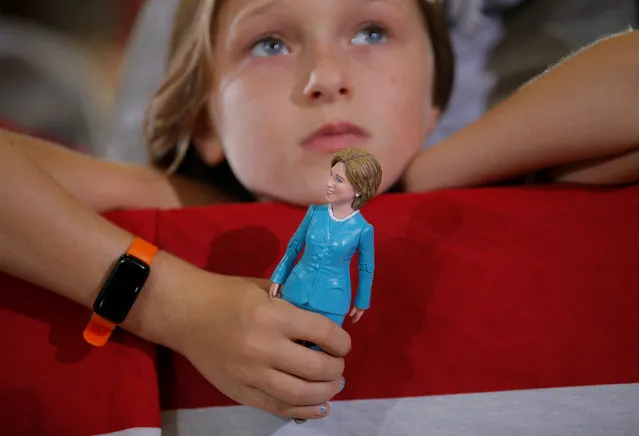 Nine-year-old Belle Shefrin holds a doll of U.S. Democratic presidential nominee Hillary Clinton while listening to Clinton speak at a campaign rally in Akron, Ohio, October 3, 2016. (Photo by Brian Snyder/Reuters)
