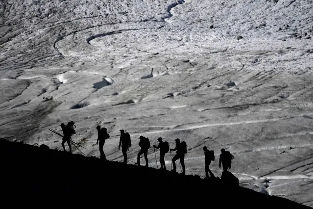 A group walks to the Jamtalferner Glacier near Galtuer, Austria, Wednesday, September 6, 2023. (Photo by Matthias Schrader/AP Photo)
