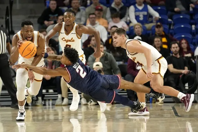 Florida Atlantic's Nicholas Boyd (2) loses control of the ball to Loyola's Patrick Mwamba as Braden Norris also defends during the second half of an NCAA college basketball game Wednesday, November 8, 2023, in Chicago. Florida Atlantic won 75-62. (Photo by Charles Rex Arbogast/AP Photo)