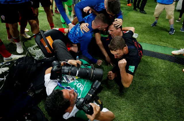Croatia players celebrate next to an AFP photographer Yuri Cortez after Mario Mandzukic scored their second goal against England during the World Cup semi-final in Moscow. (Photo by Carl Recine/Reuters)
