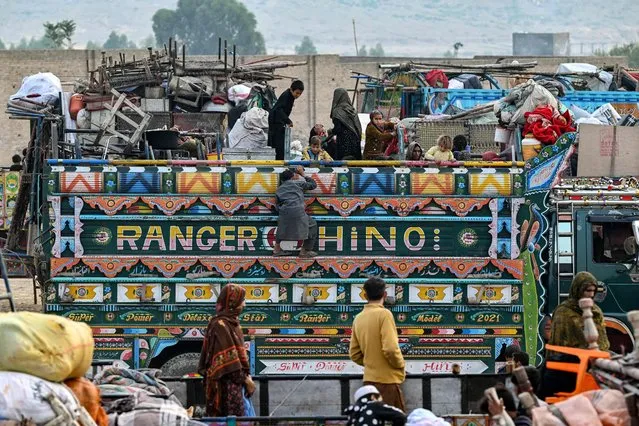 Afghan refugees arrive in a truck at a holding centre as they prepare to depart for Afghanistan, in Landi Kotal on November 1, 2023. Hundreds of thousands of Afghans living in Pakistan faced the threat of detention and deportation on November 1, as a government deadline for them to leave sparked a mass exodus. (Photo by Farooq Naeem/AFP Photo)