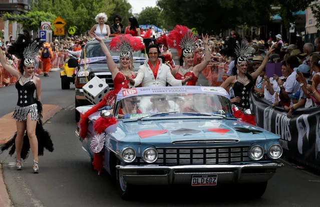 An Elvis Presley impersonator and women dressed as showgirls participate in a street parade at the 25th annual Parkes Elvis Festival in the rural Australian town of Parkes, west of Sydney, January 14, 2017. (Photo by Jason Reed/Reuters)