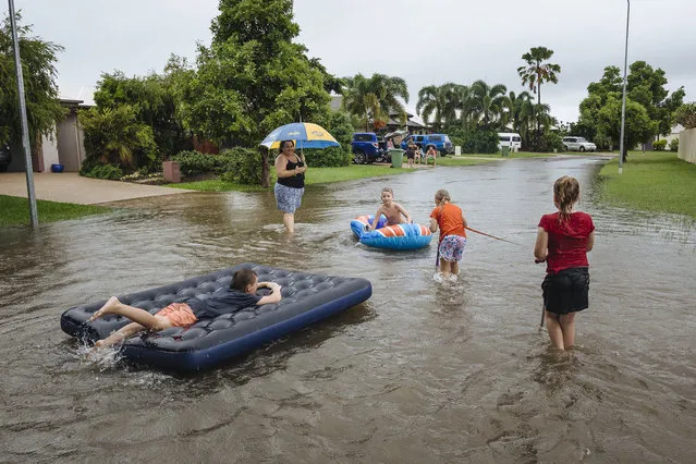Residents of the suburb of Idalia are seen playing in floodwaters in Townsville, Queensland, Australia, 01 February 2019. Authorities asked Townsville residents downstream from the Ross River dam to evacuate an emergency measure after high-risk that up to 100 homes could be flooded. (Photo by Andrew Rankin/EPA/EFE)