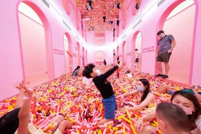 Visitors play in the “Sprinkle Pool” installation at the Museum of Ice Cream in Singapore, 03 September 2021. The New York-based Museum of Ice Cream opened its first overseas outlet in Singapore on 19 August 2021 amid strict coronavirus pandemic protocols. Spanning 60,000 square feet across five buildings, the museum features 14 unique interactive installations, a cafe and bar, and unlimited servings of ice cream. Visitors are required to be vaccinated or produce valid negative COVID-19 tests taken within 24 hours of their visit. (Photo by How Hwee Young/EPA/EFE)