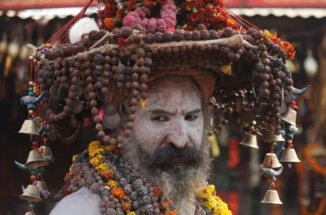 A Naga Sadhu or a Hindu holy man waits for devotees inside his camp during “Kumbh Mela” or the Pitcher Festival, in Prayagraj, previously known as Allahabad, India, February 3, 2019. (Photo by Anushree Fadnavis/Reuters)