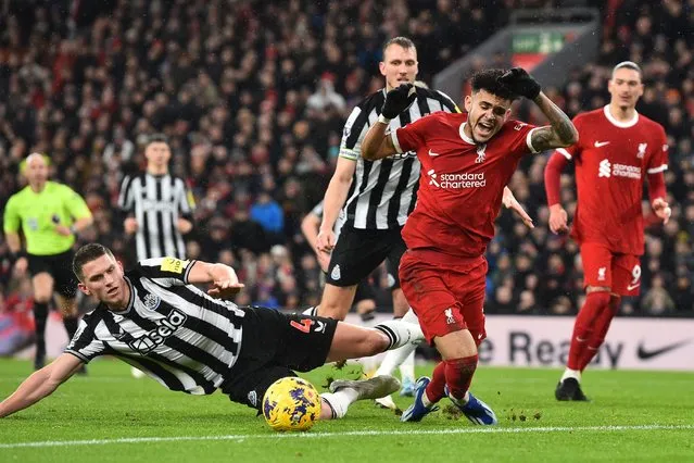 Newcastle United's Dutch defender #04 Sven Botman (L) fouls Liverpool's Colombian midfielder #07 Luis Diaz (C) for a penalty to Liverpool during the English Premier League football match between Liverpool and Newcastle United at Anfield in Liverpool, north west England on January 1, 2024. (Photo by Peter Powell/AFP Photo)