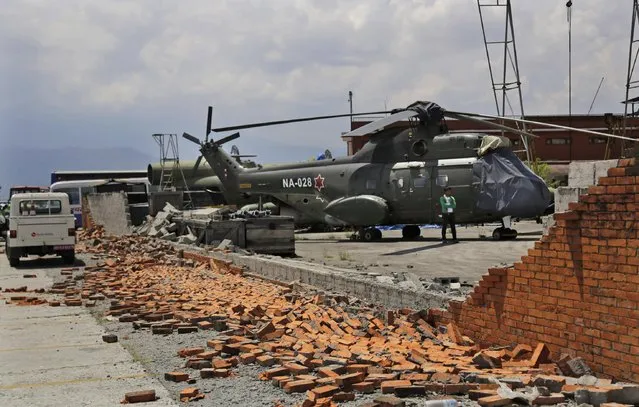 A wall at the Kathmandu airport that collapsed during Saturday's earthquake in Kathmandu, Nepal, Monday, April 27, 2015. Chaos has reigned at Kathmandu's small airport since the earthquake, with the onslaught of relief flights causing major backups on the tarmac. (Photo by Altaf Qadri/AP Photo)