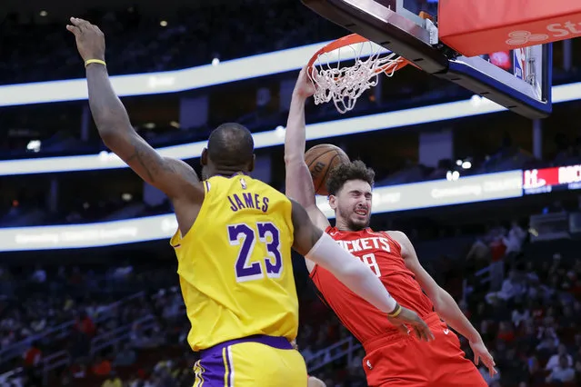 Houston Rockets center Alperen Sengun, right, dunks in front of Los Angeles Lakers forward LeBron James (23) during the second half of an NBA basketball game Monday, January 29, 2024, in Houston. (Photo by Michael Wyke/AP Photo)