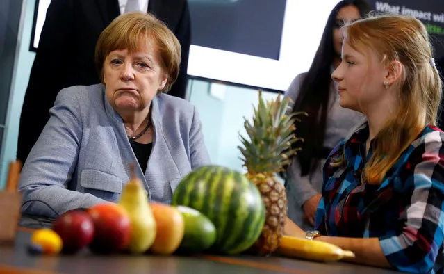 German Chancellor Angela Merkel talks to a participant of a Girls' Day career event at the Chancellery to attract female pupils to careers in IT, technological and natural science sectors of the German industry in Berlin, Germany, March 27, 2019. (Photo by Fabrizio Bensch/Reuters)