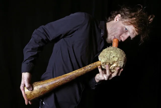 Austrian musician Matthias Meinharter, a member of the Vegetable Orchestra, poses for a picture with a musical instrument made from vegetables in Haguenau, eastern France January 15, 2014. (Photo by Vincent Kessler/Reuters)