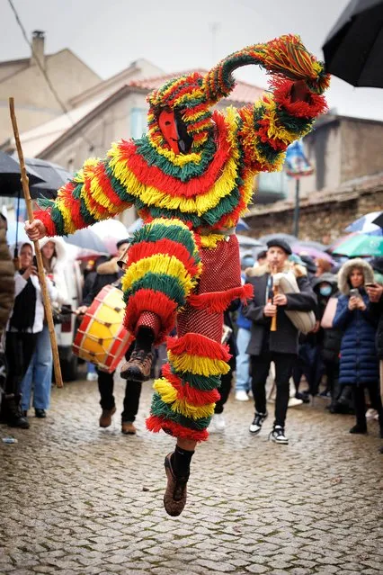 A participant dressed as “careto” during the carnival festivities of Podence, municipality of Macedo de Cavaleiros, Portugal, 11 February 2024. Every year, during carnival, the Caretos de Podence – masked boys in costumes with colourful fringes, pointed-nosed faces made of tin or leather and rattles around their waists – roam the streets of the town making noise and picking on people passing by, especially girls. (Photo by Pedro Sarmento Costa/EPA)