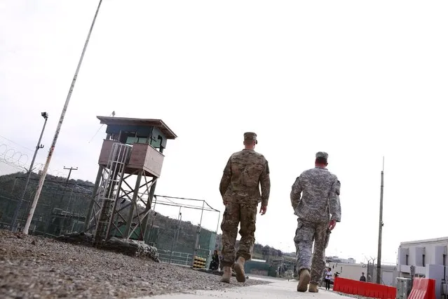 Soldiers attached to Joint Task Force Guantanamo walk through Camp Delta at the U.S. Naval Base in Guantanamo Bay, Cuba March 22, 2016. During U.S. President Barack Obama’s historic visit to Cuba this week, he pushed Cuba to improve its record on human rights and sparred with President Raul Castro, while Castro hit back by decrying U.S. “double standards”. (Photo by Lucas Jackson/Reuters)